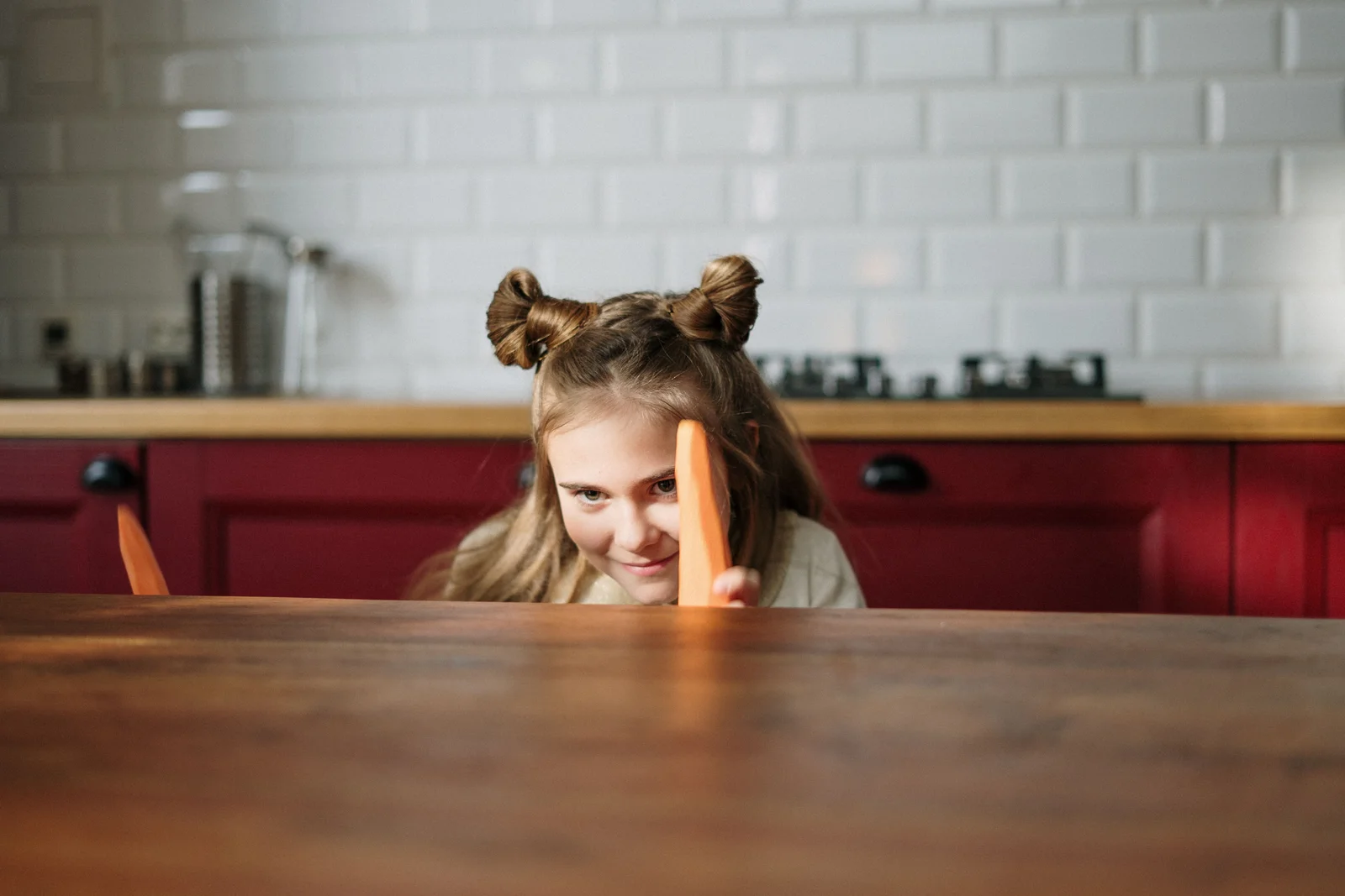 Petite fille aux cheveux bouclés coiffée en macarons